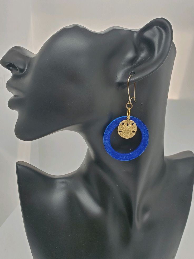 ~Welcome to Encased in Elegance!~ These are perfect for the summer! I handmade these blue resin circles and painted the backsides a nice blue color, so they are two toned blue. The kidney earrings and jump rings are 14k gold, except for the larger jump ring with is gold plated. The sanddollar is made of brass. In the photos above, the last photo shows the front and the back together. The 2nd to last photo shows the backsides only. Please do not leave resin products in the sun! Please note that t Blue Hoop Earrings With Ear Wire, Blue Hoop Earrings For Gift, Blue Dangle Hoop Earrings As Gift, Blue Dangle Hoop Earrings For Gift, Blue Ear Wire Earrings For The Beach, Blue Hoop Jewelry For The Beach, Elegant Blue Jewelry For Beach, Blue Nickel-free Hoop Earrings For Party, Blue Metal Jewelry For Beach