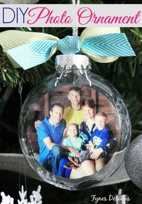 an ornament hanging from a christmas tree with a family photo on the front