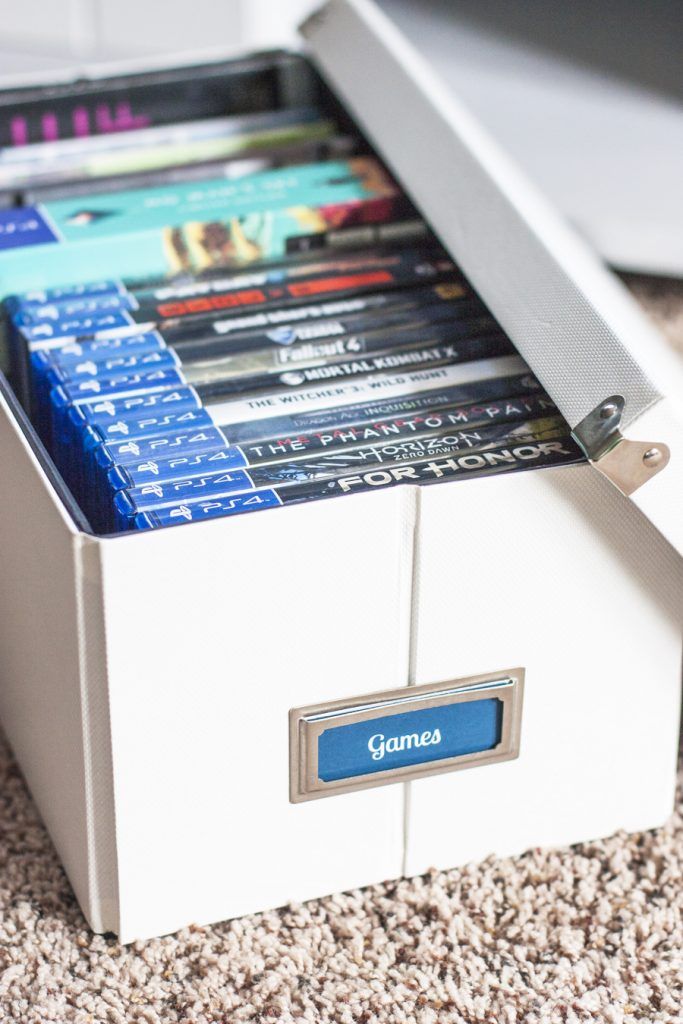 a drawer that has several different types of dvd's in it on the floor