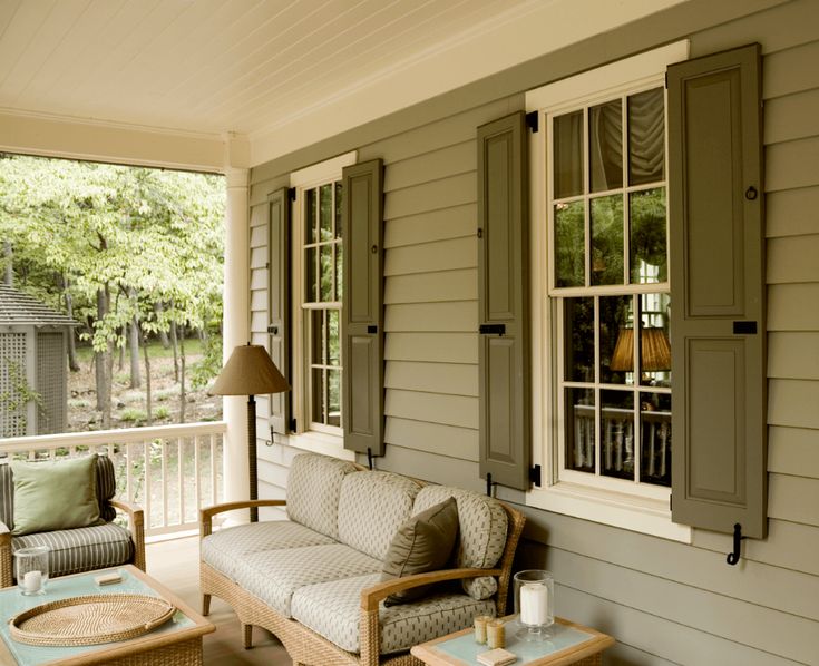 a porch with two chairs and a couch on it