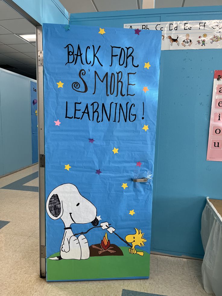 a blue door with a snoopy dog on it that says back for s'more learning