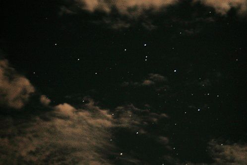 the night sky is filled with stars and clouds