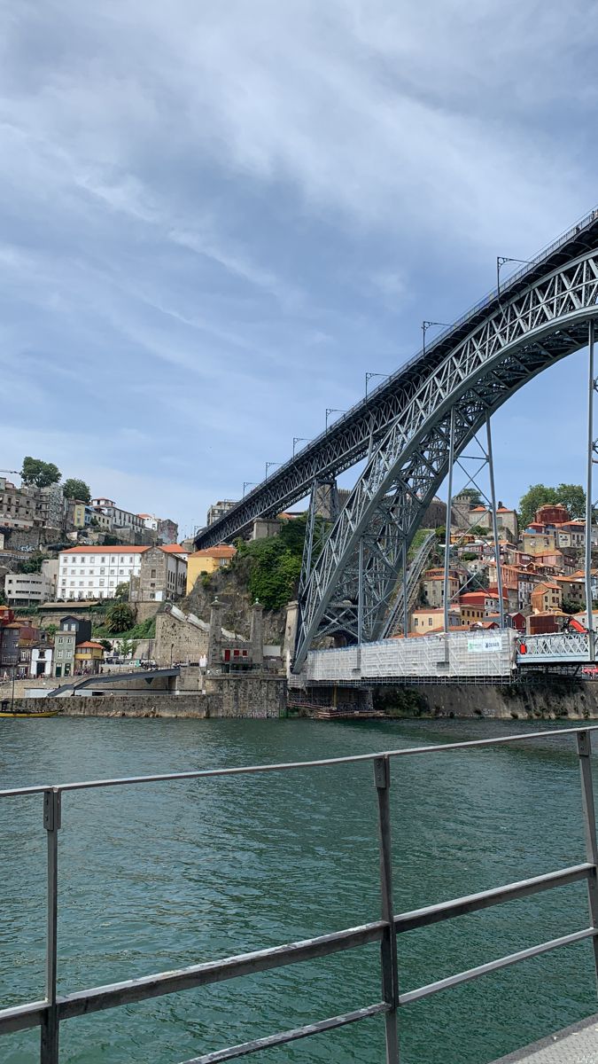 a bridge over water with buildings in the background