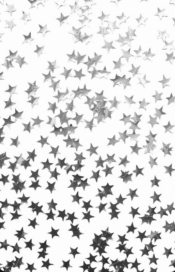 black and white stars are scattered in the air on a window sill, as if they were falling down