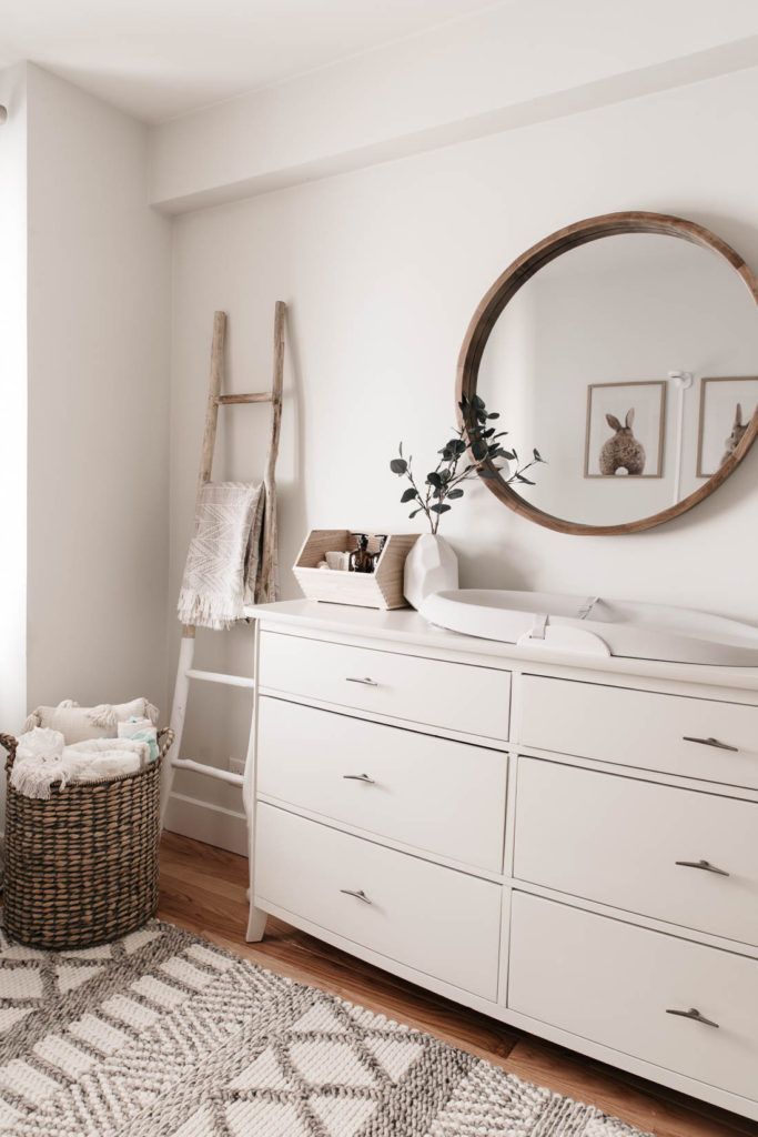 a white dresser sitting in a bedroom next to a window with an instagram sign above it