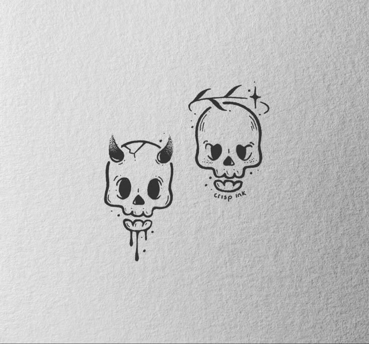 two skulls with horns on their heads are drawn in black ink, and one skull has been