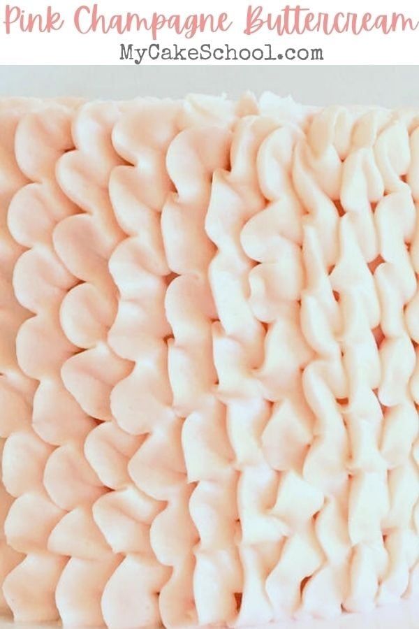 a cake with white frosting and pink icing on it