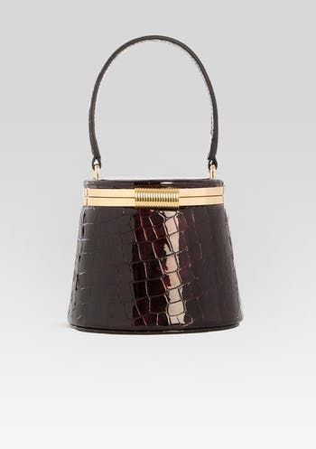 Experience elegance and versatility with the Lesla Case. With its top handle and gold hardware, this small case bag exudes luxury. The inside mirror adds functionality, while the option to wear it as a top handle or crossbody makes it perfect for any occasion Shell: 90% Velvet, 10% Metal Lining: 100% Polyester Made in China Elegant Bucket Evening Bag With Gold-tone Hardware, Modern Evening Bag With Handle Drop For Parties, Chic Formal Evening Bag With Round Handle, Luxury Gold Bucket Evening Bag, Elegant Evening Bag With Gold-tone Hardware And Round Handle, Modern Evening Bag With Round Handle For Formal Events, Glamorous Bucket Evening Bag, Elegant Evening Bag With Round Handle, Modern Formal Evening Bag With Round Handle