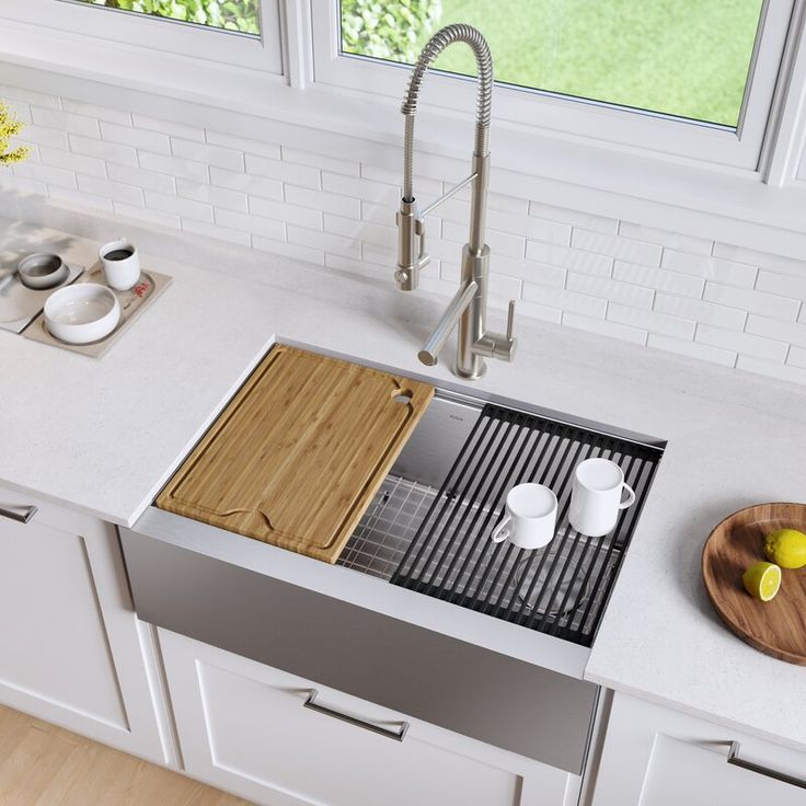 the kitchen sink is clean and ready for us to use it's own cutting board