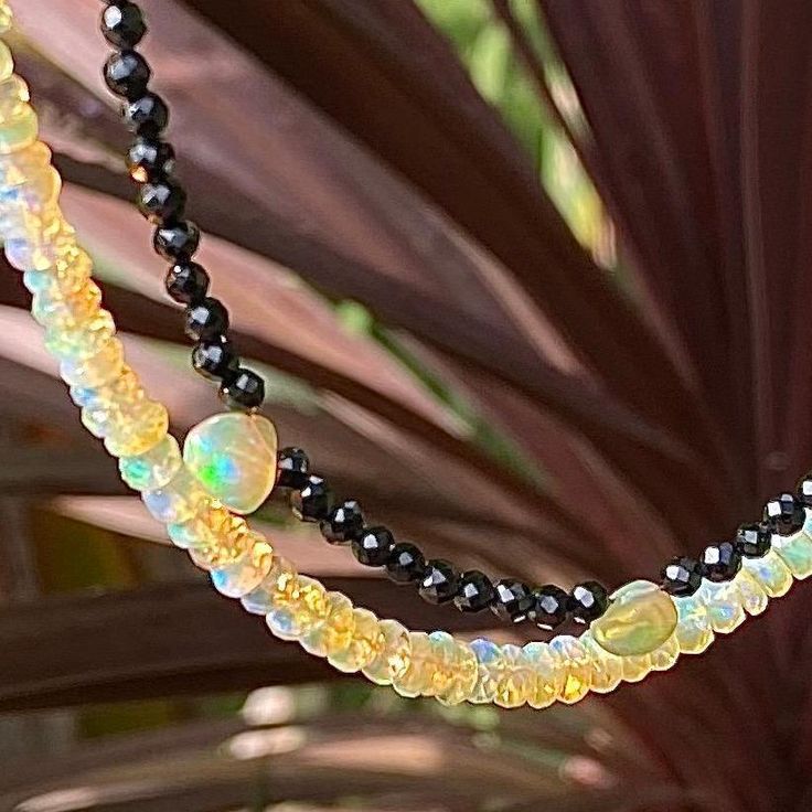 Black spinel faceted beads adorned with five golden opal drops. Length 16" Solar Plexus Xhakra - Yellow Opal is a gemstone that can create the owner's life comfortable. It is very popular as it is said that this gemstone with is bringing luck and happiness. This gemstone can protect you from daily stress and dangers. - This information is intended for spiritual support only - Beads 4mm Adjustable Black Crystal Gemstone Necklace, Black Gemstone Necklaces With Round Beads, Black Spinel Gemstone Necklace, Black Teardrop Gemstone Necklace, Black Teardrop Spiritual Necklace, Black Spiritual Teardrop Necklace, Spiritual Black Dangle Necklaces, Spiritual Black Teardrop Necklace, Black Teardrop Natural Stone Jewelry