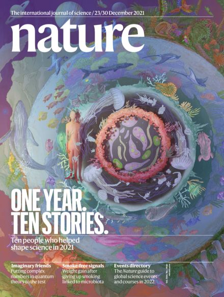 the cover of nature magazine with an image of a man standing in front of a circular object