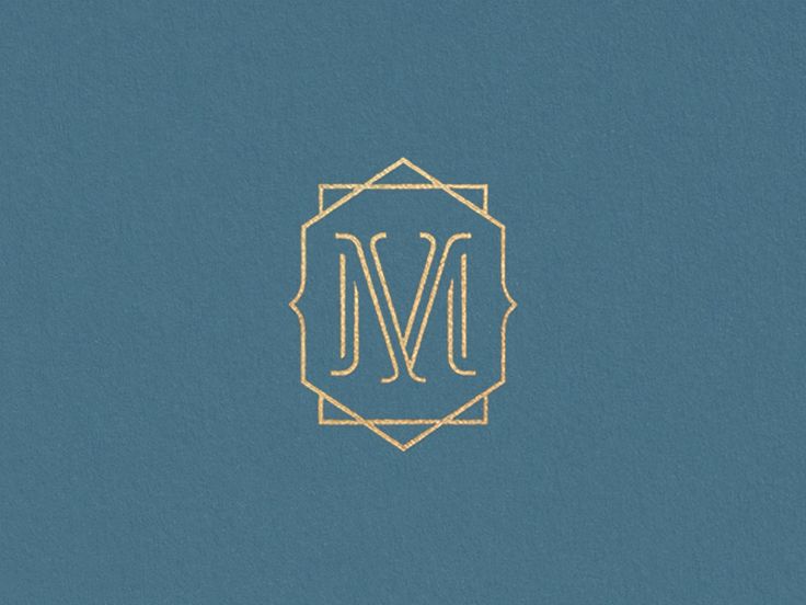 the letter m is inscribed in gold on a blue background