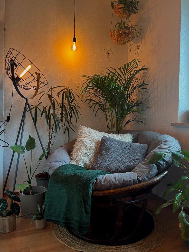 Wooden reading chair surrounded by plants and industrial lamp Bedroom Reading Corner, Cozy Reading Corners, Viborg, Bedroom Corner, Dream Apartment Decor, Dream House Rooms, Cozy Room Decor, Apartment Decor Inspiration, Reading Corner