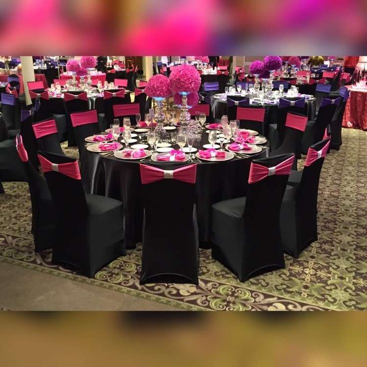 the tables are set with black and pink linens