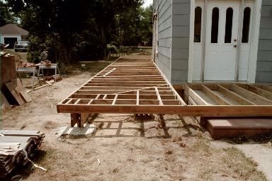 a wooden bench sitting in the middle of a yard