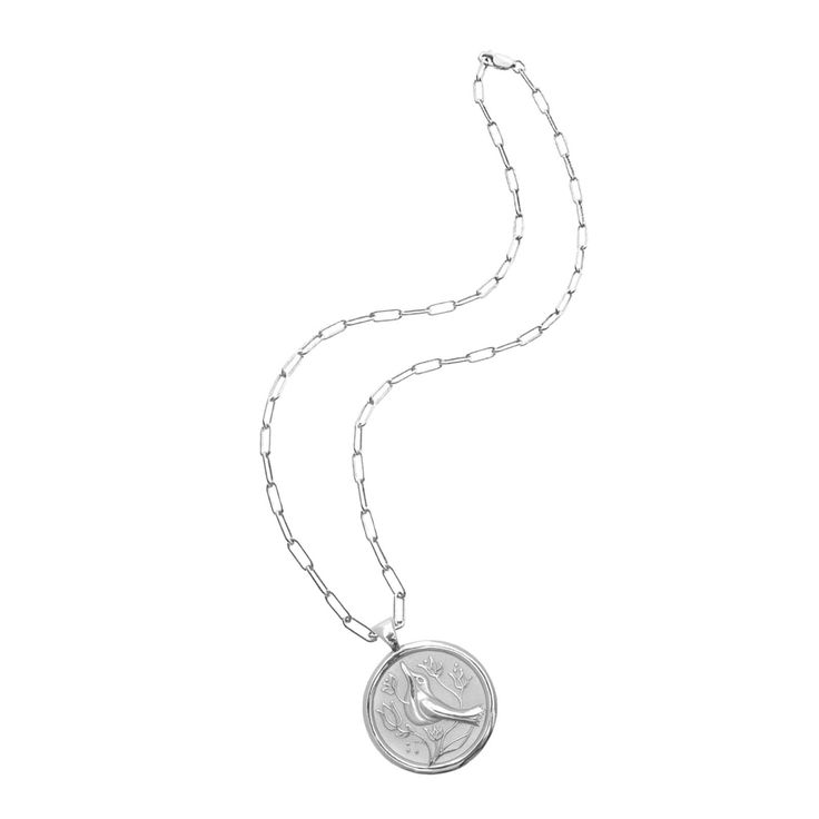 Designed as a touchstone to remember those we have lost. Hold their memory close with this recognition of all they meant to you. A tribute to your relationship and the time spent together, this coin pendant is a token to honor how much you love them still. We wish you peace. Coin pendant made of sterling silver dipped in rhodium, measuring 1.2" in diameter. DOUBLE SIDED: Bird and flowers on one side, JW logo and PEACE inscription on the other. Wear either way! Includes your choice of chain: 18" Engraved White Gold Pendant Coin Necklace, Sterling Silver Medallion Coin Necklace With Chain, Commemorative Coin Pendant Necklace, Commemoration Necklace With Coin Pendant, Commemorative White Gold Necklace With Coin Pendant, Coin Pendant Necklace For Keepsake, Commemoration Necklace With Large Round Pendant, Commemoration Coin Pendant Necklace, Anniversary Necklace With Coin Pendant