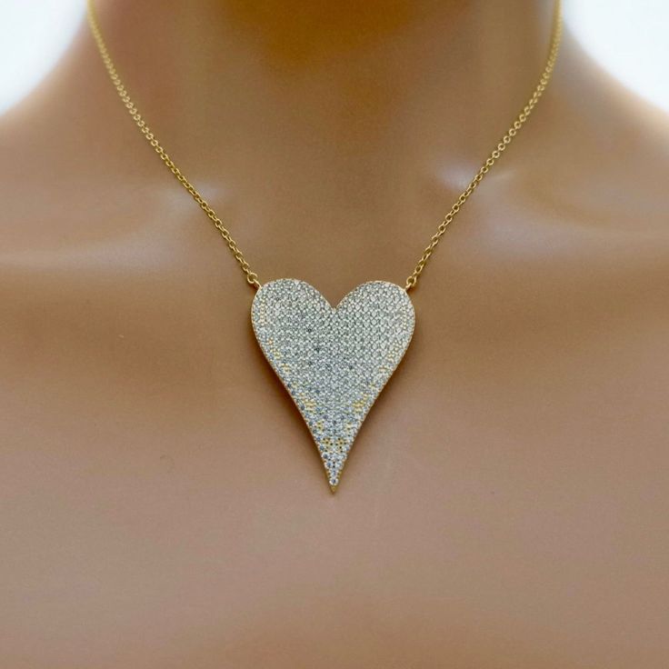 Handcrafted necklace with a giant pave crystal heart on a gold plated sterling silver chain. Necklace measures 18" in length. Wear this sweet necklace alone or layered with other necklaces from our collection. Necklace measures 18" in length Made with love in Los Angeles Complimentary gift wrapping provided All sales final. Crystal Heart Pendant Necklace For Party, Elegant Heart Pendant Jewelry With Bling, Elegant Bling Heart Pendant Jewelry, Heart Pendant Bling Jewelry For Party, Party Jewelry Heart Pendant With Bling, Heart Pendant Party Jewelry With Bling, Party Heart Pendant Jewelry With Bling, Valentine's Day Heart Pendant Jewelry With Bling, Crystal Heart Pendant Jewelry With Bling