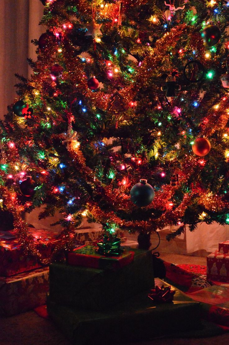 a christmas tree with presents under it