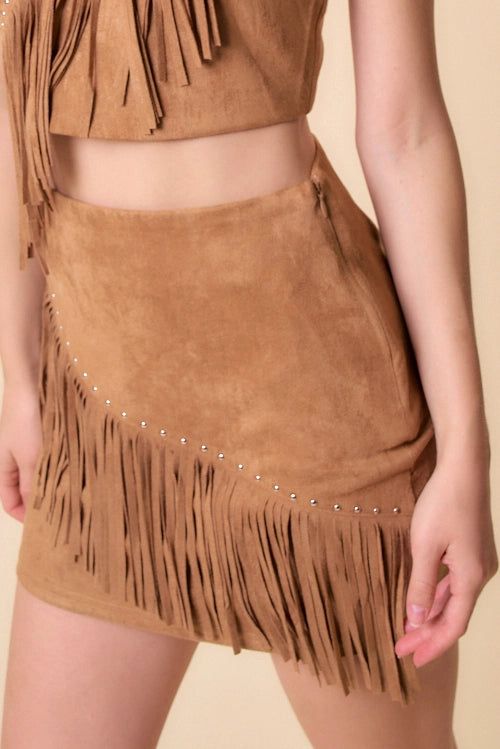 Saddle up for some serious style with the Wesley Studded Fringe Skirt! Crafted from camel suede, this mini skirt features edgy studs and a playful fringe hem. Perfect for rodeo season, this skirt is sure to make a statement. Giddy up and add it to your wardrobe today! Fall Festival Fringe Skirt, Festival Fringe Mini Skirt, Beige Fringe Skirt, Spring High Waist Fringed Mini Skirt, Leather Fringe Belt Skirt, Chic Brown Fringe Skirt, Brown Fringe Mini Skirt, Love Coupons, Fringe Skirt