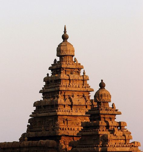 the top of an old building with statues on it