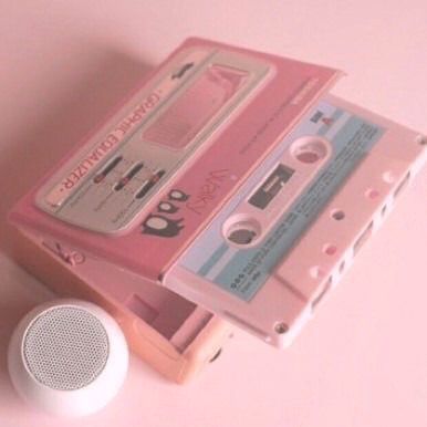 there is a pink cassette player next to an mp3 player