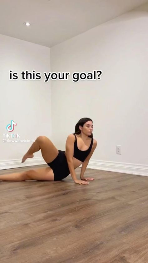 a woman is doing yoga on the floor