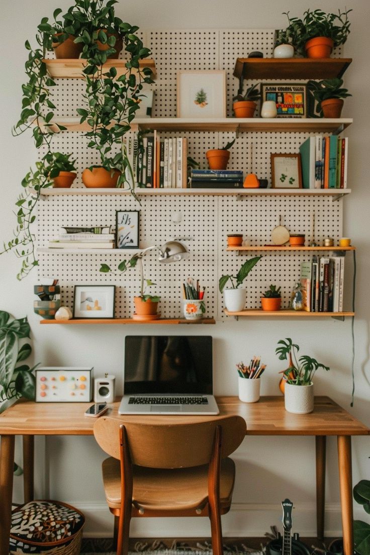 a laptop computer sitting on top of a wooden desk in front of a wall filled with potted plants