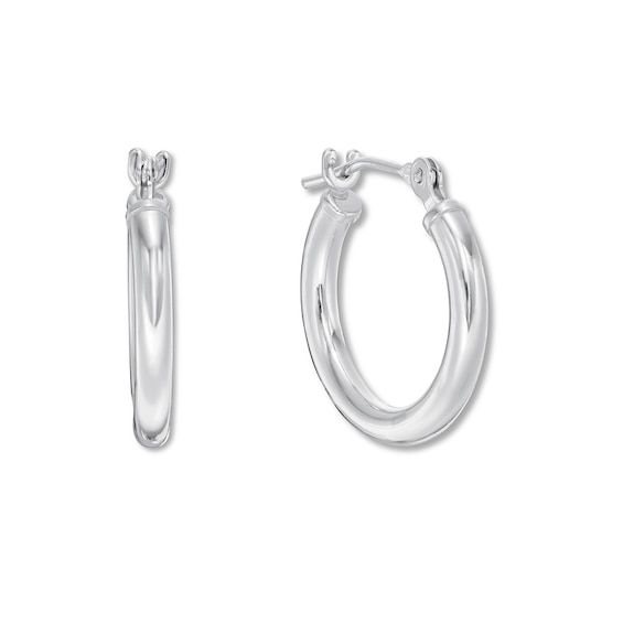 A smooth finish imbues timeless appeal to these 14K white gold hoop earrings for her. The earrings secure with hinged backs. Classic Silver Huggie Earrings With Shiny Finish, Formal Silver Small Hoop Huggie Earrings, Classic Huggie Earrings With Spring Ring Clasp For Anniversary, Classic Small Hoop Hinged Earrings, Classic Hoop Earrings With Sterling Silver Clasp, Elegant Sterling Silver Clasp Hoop Earrings For Everyday, Classic Small Hoop Huggie Earrings With Polished Finish, Elegant Hoop Earrings With Sterling Silver Clasp For Everyday, Elegant Round Hinged Huggie Earrings