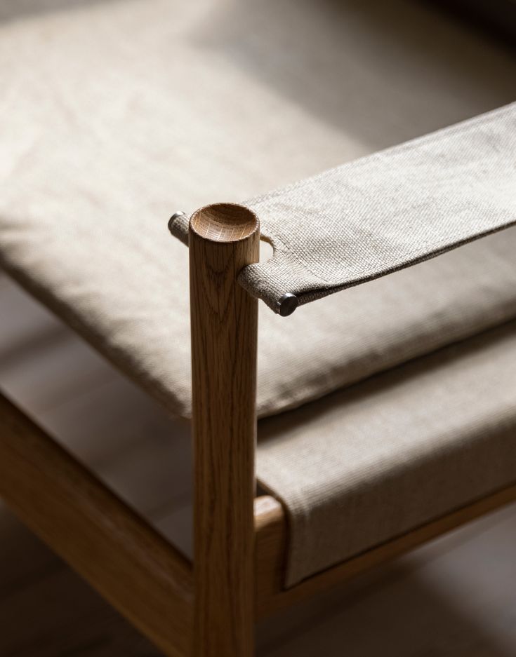 a close up of a wooden chair with a cloth on it