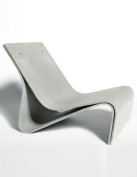 a concrete chair sitting on top of a white floor