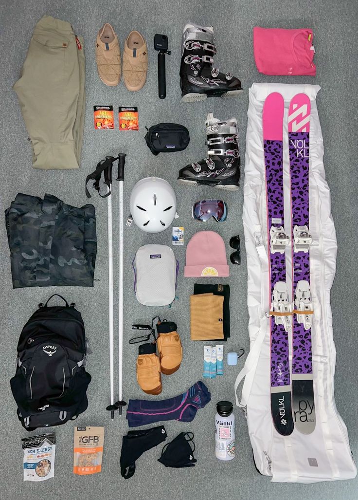 ski equipment laid out on the ground with snow shoes, backpacks and other items