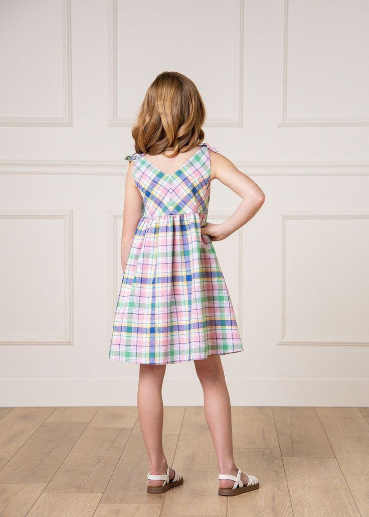 Eyelet feels fresh and fun in our bestselling bow shoulder summer dress. Features adorable bows at the shoulders, v-neck silhouette, a full lining, and a side zipper for easy dressing. Comfortable to play and move in, but still has a beautiful and flattering silhouette that could be dressed up for a special event. 55% Linen, 45% Organic Cotton, exclusive of trims. Garment is OCS-Certified. Fully lined in 100% Organic Cotton. Zipper at side seam for easy on and off. Machine washable. Hope & Henry Playful Sleeveless Dress With Bow, V-neck Spring Dresses With Bow Detail, Cotton Dress With Bow Tie Back For Garden Party, Spring Cotton Dress With Bow Straps, Spring Picnic Dress With Bow, Cute Tie Back Dress For Picnic, Spring Multicolor Dress With Bow, Casual Dresses With Bow Straps For Garden Party, Summer V-neck Dress With Bow Tie Back