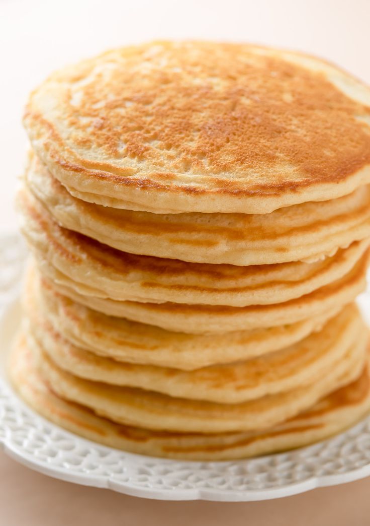 a stack of pancakes sitting on top of a white plate