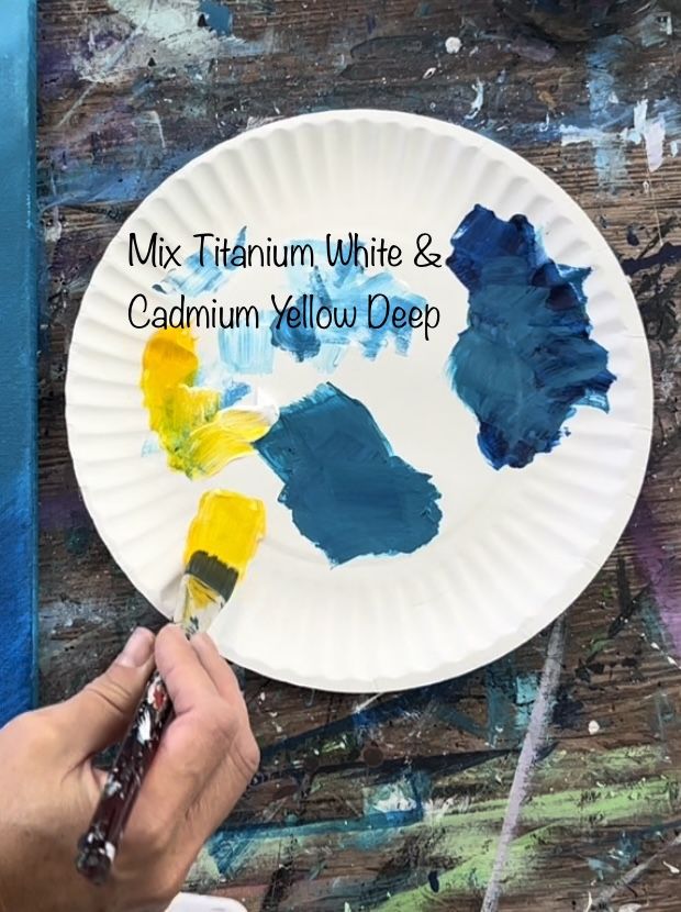 a person is painting a plate with blue and yellow paint on it that says mix them white & cadmium yellow deep