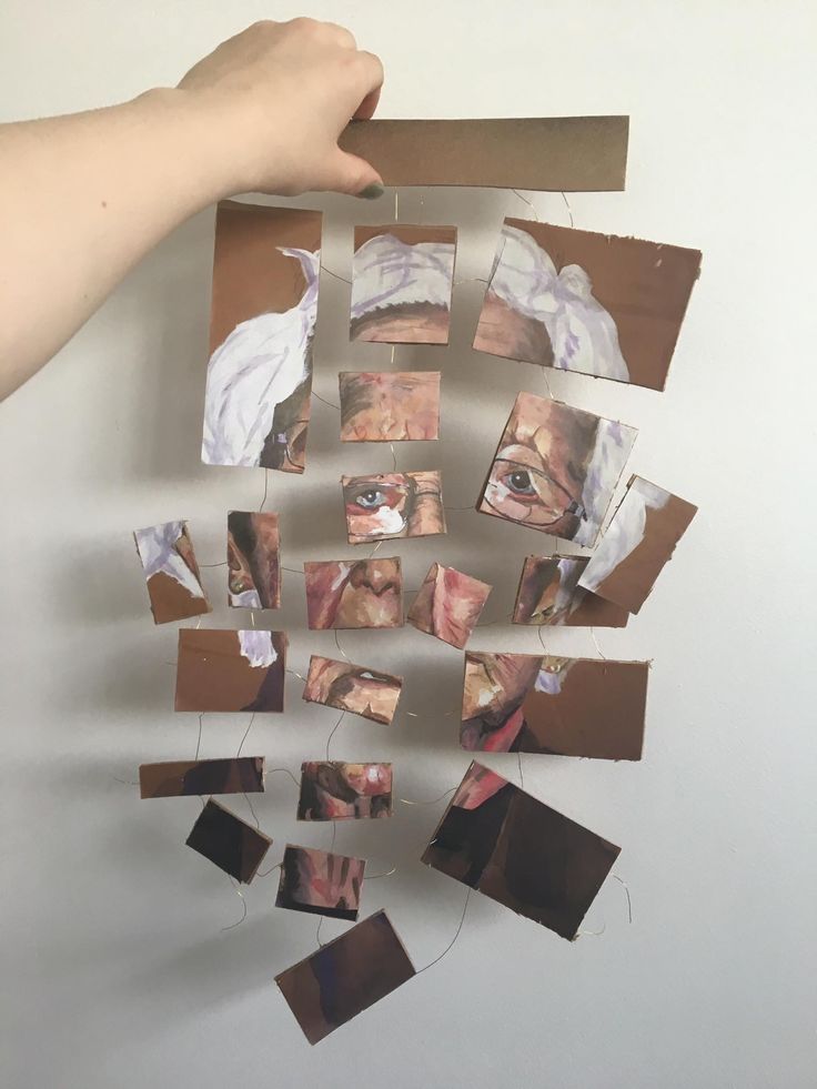 someone is holding up some pictures on a piece of cardboard with torn paper around them