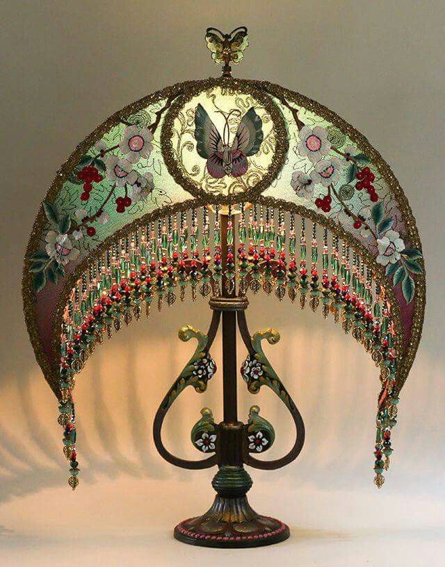 an elaborately designed lamp is lit up in the dark