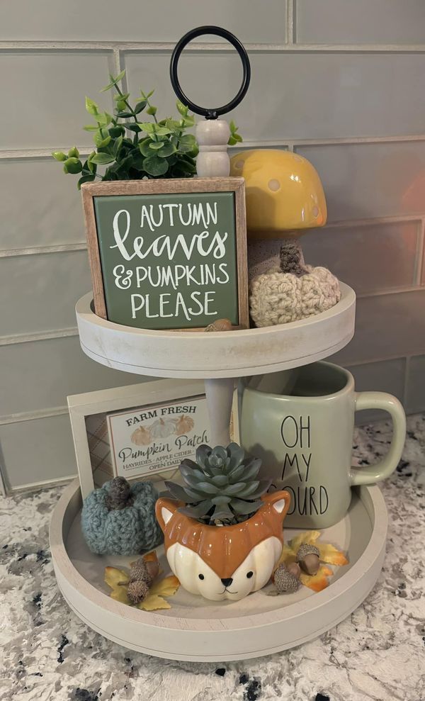 three tiered tray with coffee mugs and other items on it, along with a sign that says autumn leaves & pumpkins please