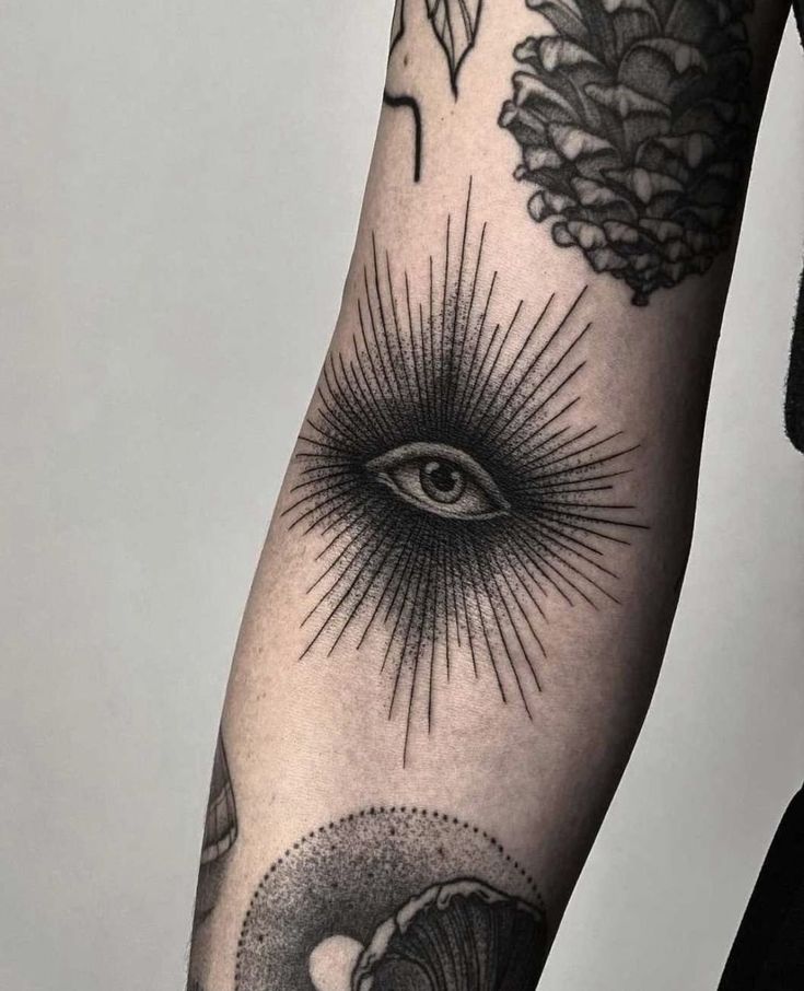 an all seeing and eye tattoo on the arm