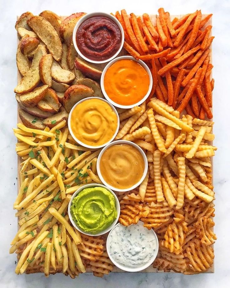 a platter filled with french fries and dips