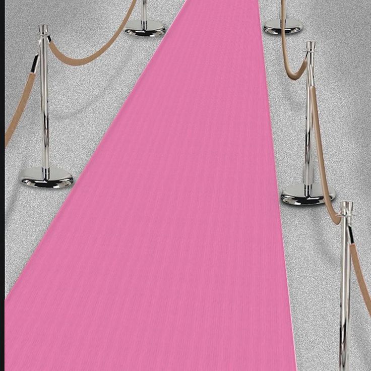 a long pink carpeted hallway with ropes and poles on the floor next to it