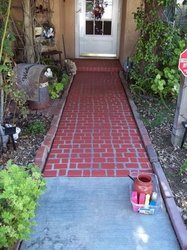 a red brick walkway leading to a white door