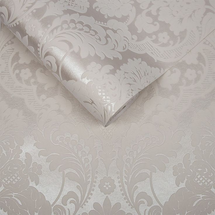 the wall paper is white and has silver designs on it