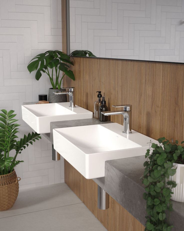 two white sinks sitting next to each other in a bathroom