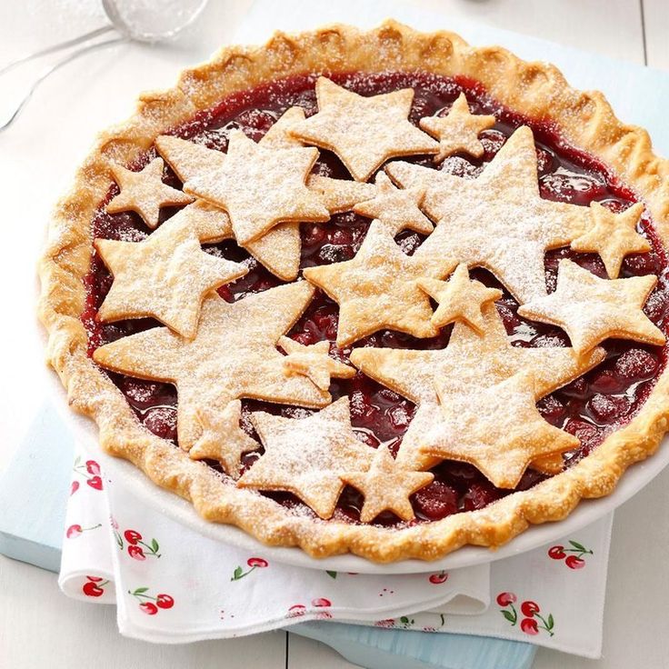 a pie topped with stars on top of a table