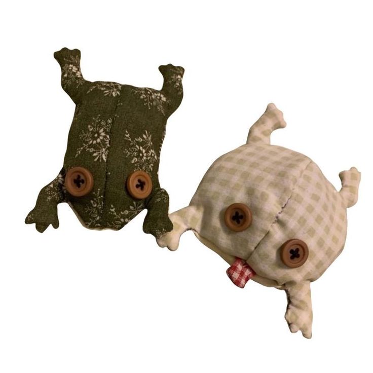 two stuffed animals with buttons on their backs