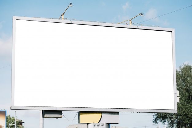 a large white billboard on the side of a road