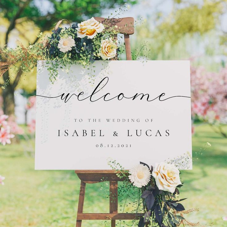 a welcome sign sitting on top of a wooden easel