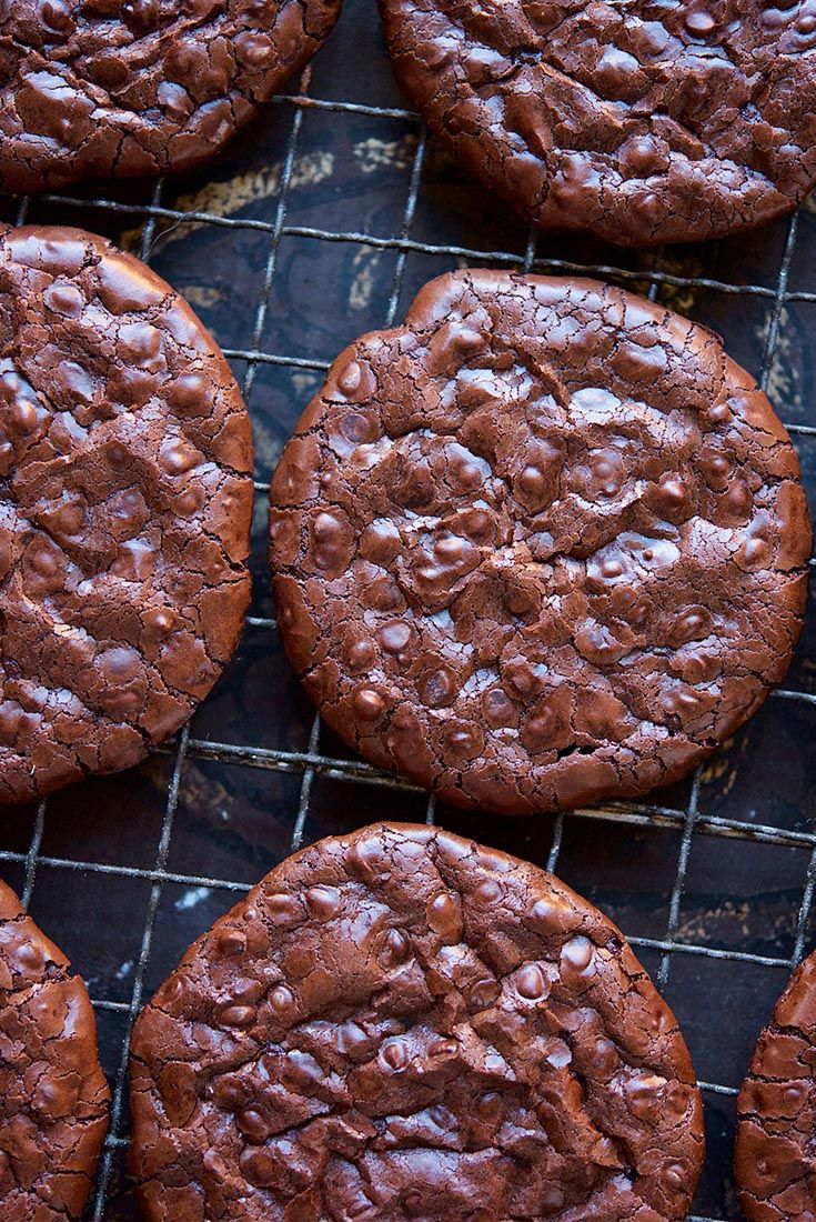 chocolate cookies cooling on a wire rack with water droplets all over the top and bottom