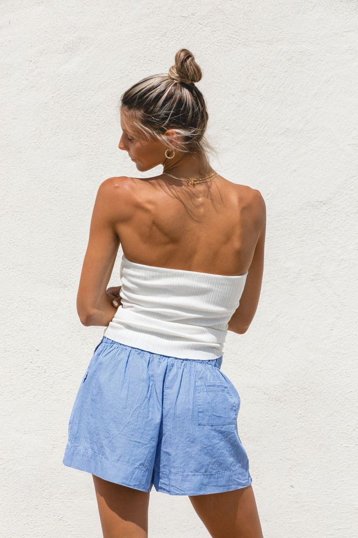 Expertly crafted with a ribbed knit, our High Noon Tube Top offers both comfort and versatility. Its long length provides ample coverage and pairs well with high-waisted bottoms. Perfect by itself or to layer under a breezy button up, this white sweater tube top is a must-have for any wardrobe. Ribbed Bottoms For Vacation, Fitted Ribbed Beach Bottoms, Fitted Ribbed Bottoms For Beach, Fitted Ribbed Bottoms For The Beach, Ribbed Tops For Beach, Solid Ribbed Bottoms For Summer, Ribbed Bottoms For Vacation In Spring, Stretch Ribbed Bottoms, Ribbed Loungewear Bottoms