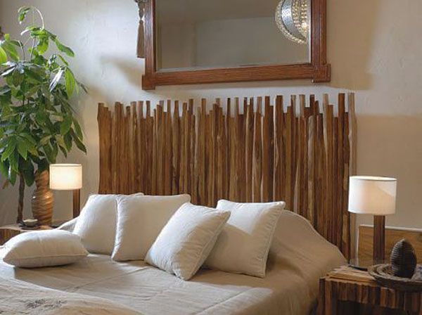 a bed with white pillows and wooden headboard